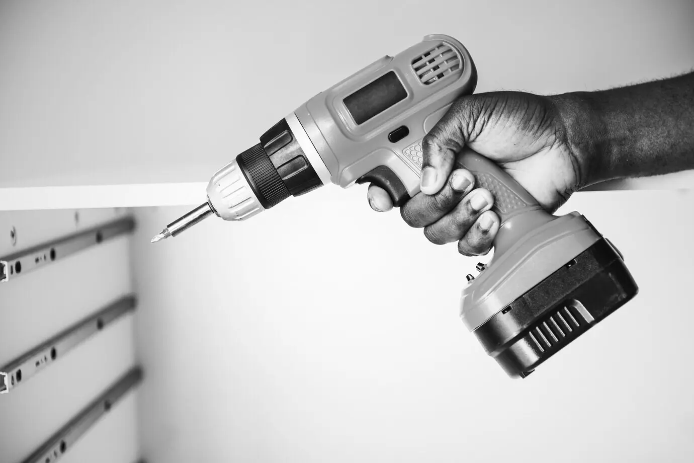 A man operating an electronic drill.
